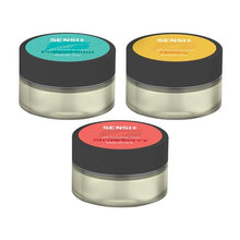 Load image into Gallery viewer, Three cosmetic jars labeled &quot;Sensi Skin&quot; are shown, each containing a different flavor variant: mint-green for &quot;Peppermint,&quot; yellow-orange for &quot;Honey,&quot; and red for &quot;Strawberry.&quot; These vegan-friendly Sensi Skin 100mg CBD Lip Balms have black lids and transparent bases revealing the vibrant colors inside, with each jar featuring 100mg of CBD. Don&#39;t miss the special offer: buy one and get one free!
